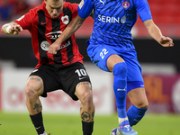 Roger Krug Guedes (L) of Al Rayyan SC battles for the ball with Andreas Van Beek (R) of Al Shahania SC during the Ooredoo Qatar Stars League...