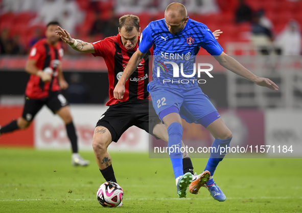 Roger Krug Guedes (L) of Al Rayyan SC battles for the ball with Andreas Van Beek (R) of Al Shahania SC during the Ooredoo Qatar Stars League...