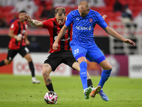 Roger Krug Guedes (L) of Al Rayyan SC battles for the ball with Andreas Van Beek (R) of Al Shahania SC during the Ooredoo Qatar Stars League...