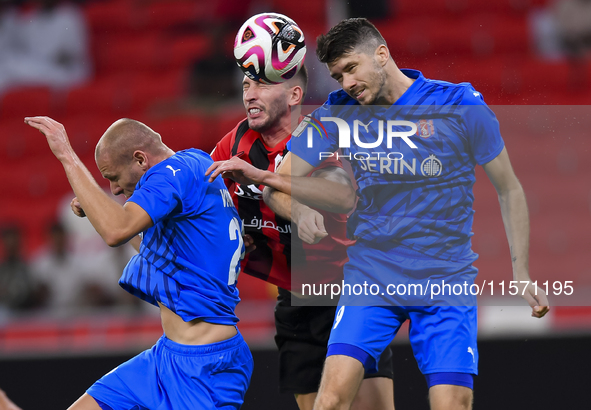 David Garcia (C) of Al Rayyan SC battles for the ball with Petrus Amersfoort (R) of Al Shahania SC during the Ooredoo Qatar Stars League 24/...