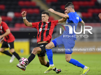 Andre Amaro (L) of Al Rayyan SC battles for the ball with Petrus Amersfoort (R) of Al Shahania SC during the Ooredoo Qatar Stars League 24/2...