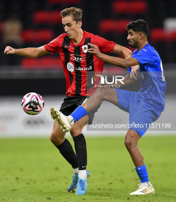 Julien Ariel De Sart (L) of Al Rayyan SC battles for the ball with Naif Abdulraheem Alhadhrami (R) of Al Shahania SC during the Ooredoo Qata...