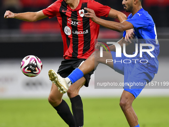 Julien Ariel De Sart (L) of Al Rayyan SC battles for the ball with Naif Abdulraheem Alhadhrami (R) of Al Shahania SC during the Ooredoo Qata...