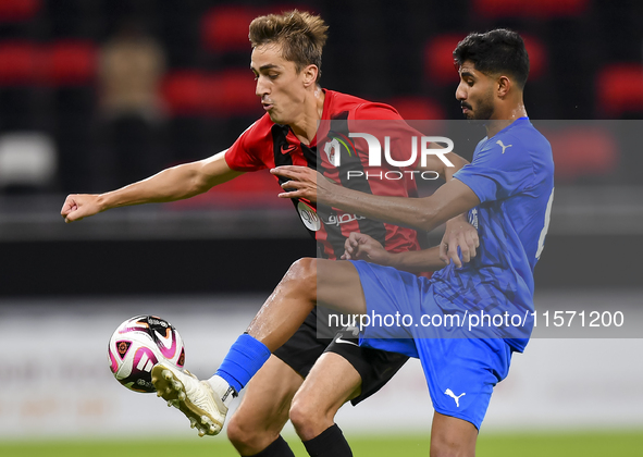 Julien Ariel De Sart (L) of Al Rayyan SC battles for the ball with Naif Abdulraheem Alhadhrami (R) of Al Shahania SC during the Ooredoo Qata...