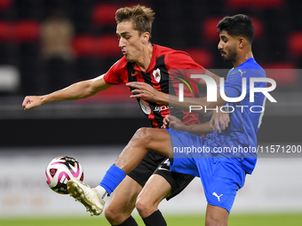 Julien Ariel De Sart (L) of Al Rayyan SC battles for the ball with Naif Abdulraheem Alhadhrami (R) of Al Shahania SC during the Ooredoo Qata...