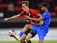 Julien Ariel De Sart (L) of Al Rayyan SC battles for the ball with Naif Abdulraheem Alhadhrami (R) of Al Shahania SC during the Ooredoo Qata...