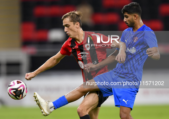 Julien Ariel De Sart (L) of Al Rayyan SC battles for the ball with Naif Abdulraheem Alhadhrami (R) of Al Shahania SC during the Ooredoo Qata...