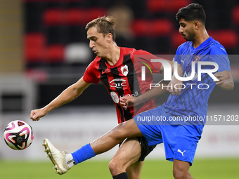 Julien Ariel De Sart (L) of Al Rayyan SC battles for the ball with Naif Abdulraheem Alhadhrami (R) of Al Shahania SC during the Ooredoo Qata...