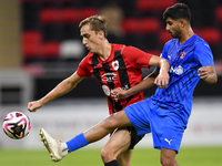 Julien Ariel De Sart (L) of Al Rayyan SC battles for the ball with Naif Abdulraheem Alhadhrami (R) of Al Shahania SC during the Ooredoo Qata...