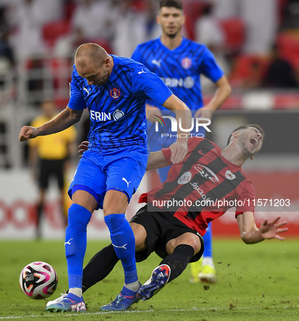 David Garcia (R) of Al Rayyan SC battles for the ball with Andreas Van Beek (L) of Al Shahania SC during the Ooredoo Qatar Stars League 24/2...