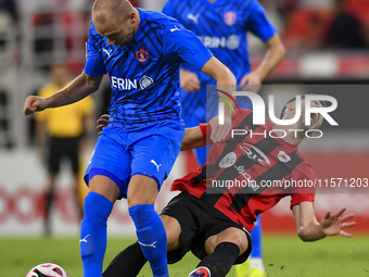 David Garcia (R) of Al Rayyan SC battles for the ball with Andreas Van Beek (L) of Al Shahania SC during the Ooredoo Qatar Stars League 24/2...