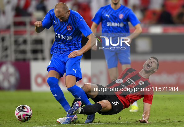 David Garcia (R) of Al Rayyan SC battles for the ball with Andreas Van Beek (L) of Al Shahania SC during the Ooredoo Qatar Stars League 24/2...