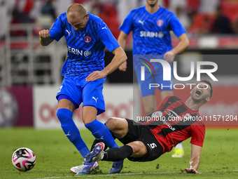 David Garcia (R) of Al Rayyan SC battles for the ball with Andreas Van Beek (L) of Al Shahania SC during the Ooredoo Qatar Stars League 24/2...