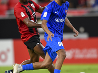 Thiago Henrique Mendes (L) of Al Rayyan SC battles for the ball with Andreas Van Beek (R) of Al Shahania SC during the Ooredoo Qatar Stars L...