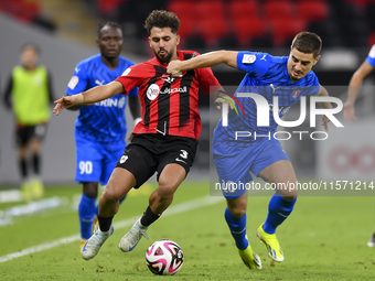 Hazem Ahmed Shehata (L) of Al Rayyan SC battles for the ball with Francesco Antonucci (R) of Al Shahania SC during the Ooredoo Qatar Stars L...