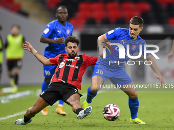 Hazem Ahmed Shehata (L) of Al Rayyan SC battles for the ball with Francesco Antonucci (R) of Al Shahania SC during the Ooredoo Qatar Stars L...