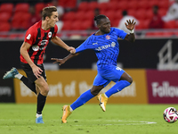 Julien Ariel De Sart (L) of Al Rayyan SC battles for the ball with Alhassan Koroma (R) of Al Shahania SC during the Ooredoo Qatar Stars Leag...