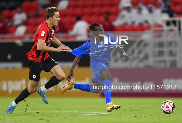 Julien Ariel De Sart (L) of Al Rayyan SC battles for the ball with Alhassan Koroma (R) of Al Shahania SC during the Ooredoo Qatar Stars Leag...