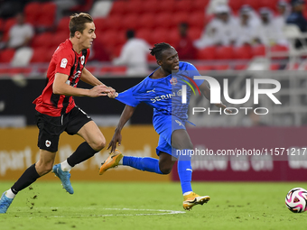 Julien Ariel De Sart (L) of Al Rayyan SC battles for the ball with Alhassan Koroma (R) of Al Shahania SC during the Ooredoo Qatar Stars Leag...