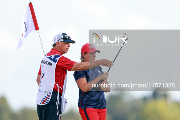 GAINESVILLE, VIRGINIA - SEPTEMBER 13: Lauren Coughlin of the United States looks over the 16th green with her caddie during Day One of the S...