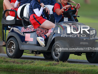 GAINESVILLE, VIRGINIA - SEPTEMBER 13: Members of Team USA travel by golf cart from the 14th fairway during Day One of the Solheim Cup at Rob...