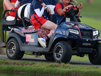 GAINESVILLE, VIRGINIA - SEPTEMBER 13: Members of Team USA travel by golf cart from the 14th fairway during Day One of the Solheim Cup at Rob...