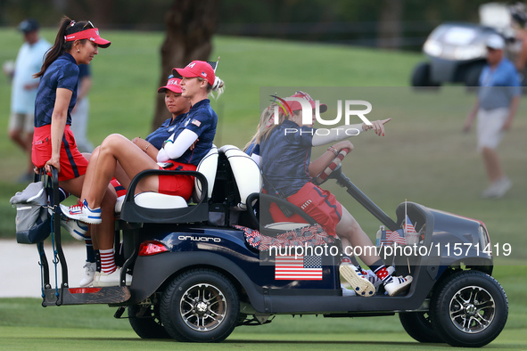 GAINESVILLE, VIRGINIA - SEPTEMBER 13: Members of Team USA travel by golf cart from the 14th green during Day One of the Solheim Cup at Rober...