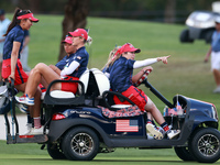 GAINESVILLE, VIRGINIA - SEPTEMBER 13: Members of Team USA travel by golf cart from the 14th green during Day One of the Solheim Cup at Rober...