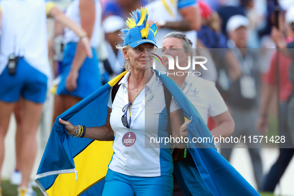 GAINESVILLE, VIRGINIA - SEPTEMBER 13:  A guest of Team Europe wearing spirit wear walks off of the 14th green at the conclusion of the group...