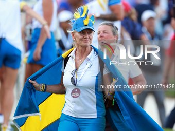 GAINESVILLE, VIRGINIA - SEPTEMBER 13:  A guest of Team Europe wearing spirit wear walks off of the 14th green at the conclusion of the group...