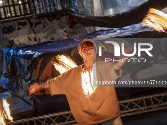 A young Iranian woman performs with fire at Adrenaline Park in Tehran, Iran, on September 13, 2024. Adrenaline Park is founded by Amir Badri...