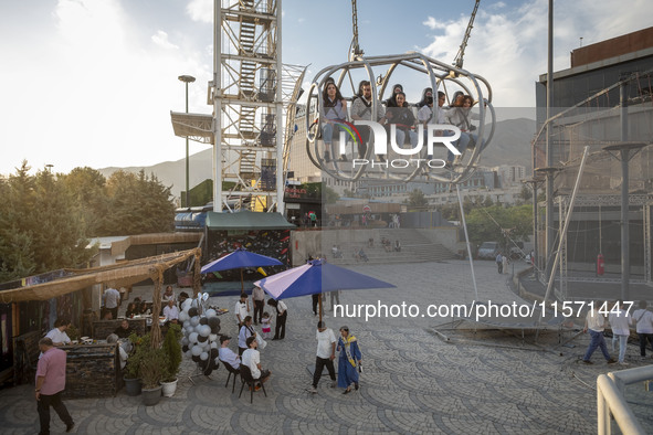 Iranian youths sit on a huge swing at Adrenaline Park in Tehran, Iran, on September 13, 2024. Amir Badri, an Iranian stuntman and award winn...