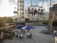 Iranian youths sit on a huge swing at Adrenaline Park in Tehran, Iran, on September 13, 2024. Amir Badri, an Iranian stuntman and award winn...