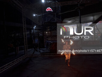 A young Iranian woman performs with fire at Adrenaline Park in Tehran, Iran, on September 13, 2024. Adrenaline Park is founded by Amir Badri...