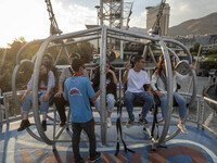 Iranian youths sit on a huge swing at Adrenaline Park in Tehran, Iran, on September 13, 2024. Amir Badri, an Iranian stuntman and award winn...