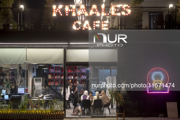 An Iranian family sits at a cafe at Adrenaline Park in Tehran, Iran, on September 13, 2024. Amir Badri, an Iranian stuntman and award winner...