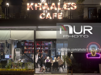 An Iranian family sits at a cafe at Adrenaline Park in Tehran, Iran, on September 13, 2024. Amir Badri, an Iranian stuntman and award winner...