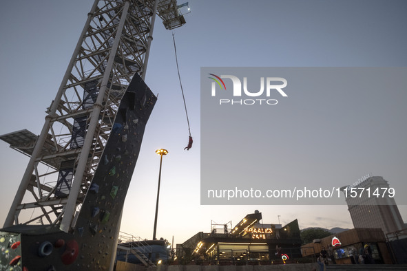 A young Iranian woman performs a bungee jump from a 40-meter rig at Adrenaline Park in Tehran, Iran, on September 13, 2024. Adrenaline Park...