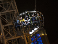 Iranian youths react while sitting on a huge swing at Adrenaline Park in Tehran, Iran, on September 13, 2024. Amir Badri, an Iranian stuntma...