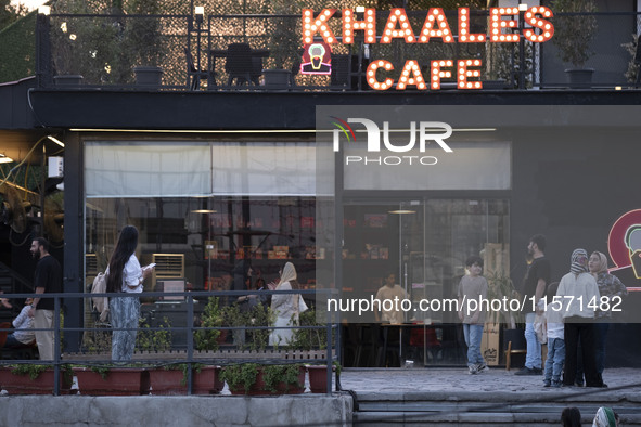 Iranian youths stand outside a cafe at Adrenaline Park in Tehran, Iran, on September 13, 2024. Amir Badri, an Iranian stuntman and award win...