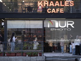 Iranian youths stand outside a cafe at Adrenaline Park in Tehran, Iran, on September 13, 2024. Amir Badri, an Iranian stuntman and award win...