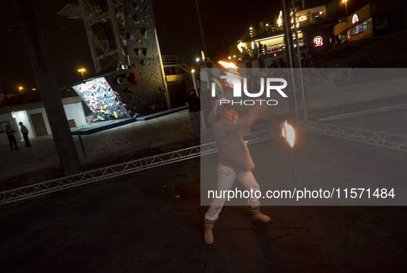 A young Iranian woman performs with fire at Adrenaline Park in Tehran, Iran, on September 13, 2024. Adrenaline Park is founded by Amir Badri...