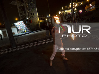 A young Iranian woman performs with fire at Adrenaline Park in Tehran, Iran, on September 13, 2024. Adrenaline Park is founded by Amir Badri...