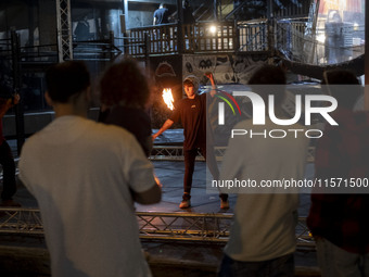 A young Iranian woman performs with fire at Adrenaline Park in Tehran, Iran, on September 13, 2024. Adrenaline Park is founded by Amir Badri...