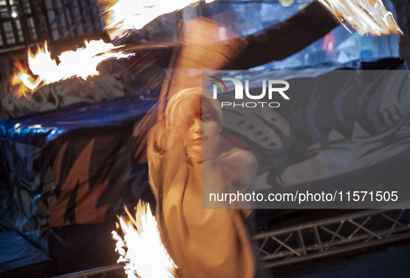 A young Iranian woman performs with fire at Adrenaline Park in Tehran, Iran, on September 13, 2024. Adrenaline Park is founded by Amir Badri...