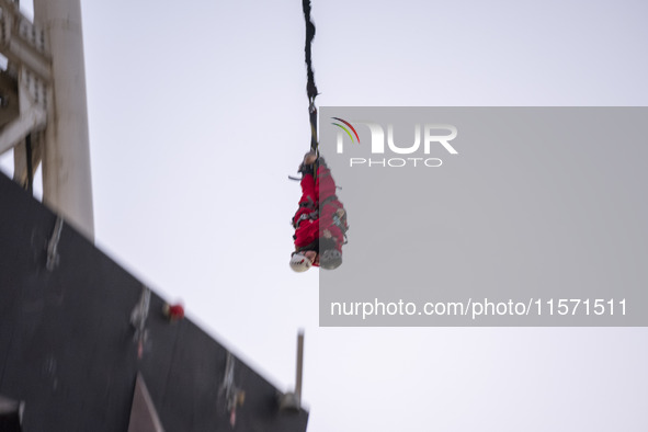 Two young Iranian women perform a bungee jump from a 40-meter rig at Adrenaline Park in Tehran, Iran, on September 13, 2024. Adrenaline Park...