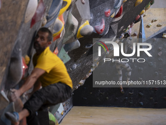 Two young Iranian rock climbers climb a wall at Adrenaline Park in Tehran, Iran, on September 13, 2024. Amir Badri, an Iranian stuntman and...