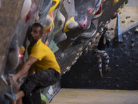 Two young Iranian rock climbers climb a wall at Adrenaline Park in Tehran, Iran, on September 13, 2024. Amir Badri, an Iranian stuntman and...