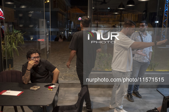 Iranian youths sit at a cafe at Adrenaline Park in Tehran, Iran, on September 13, 2024. Amir Badri, an Iranian stuntman and award winner of...