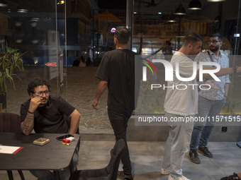 Iranian youths sit at a cafe at Adrenaline Park in Tehran, Iran, on September 13, 2024. Amir Badri, an Iranian stuntman and award winner of...